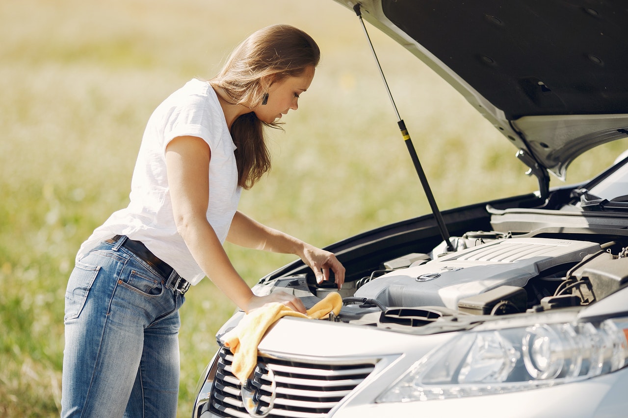 woman repairing car